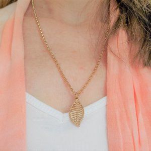 Satin gold plated necklace with open leaf pendant.